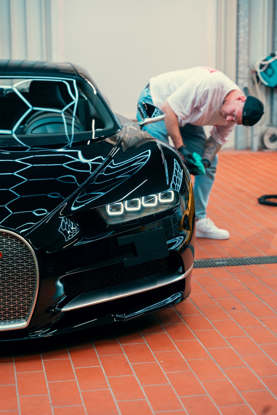 Bugatti Chiron in high-end studio undergoing multi-stage paint correction before ceramic coating application