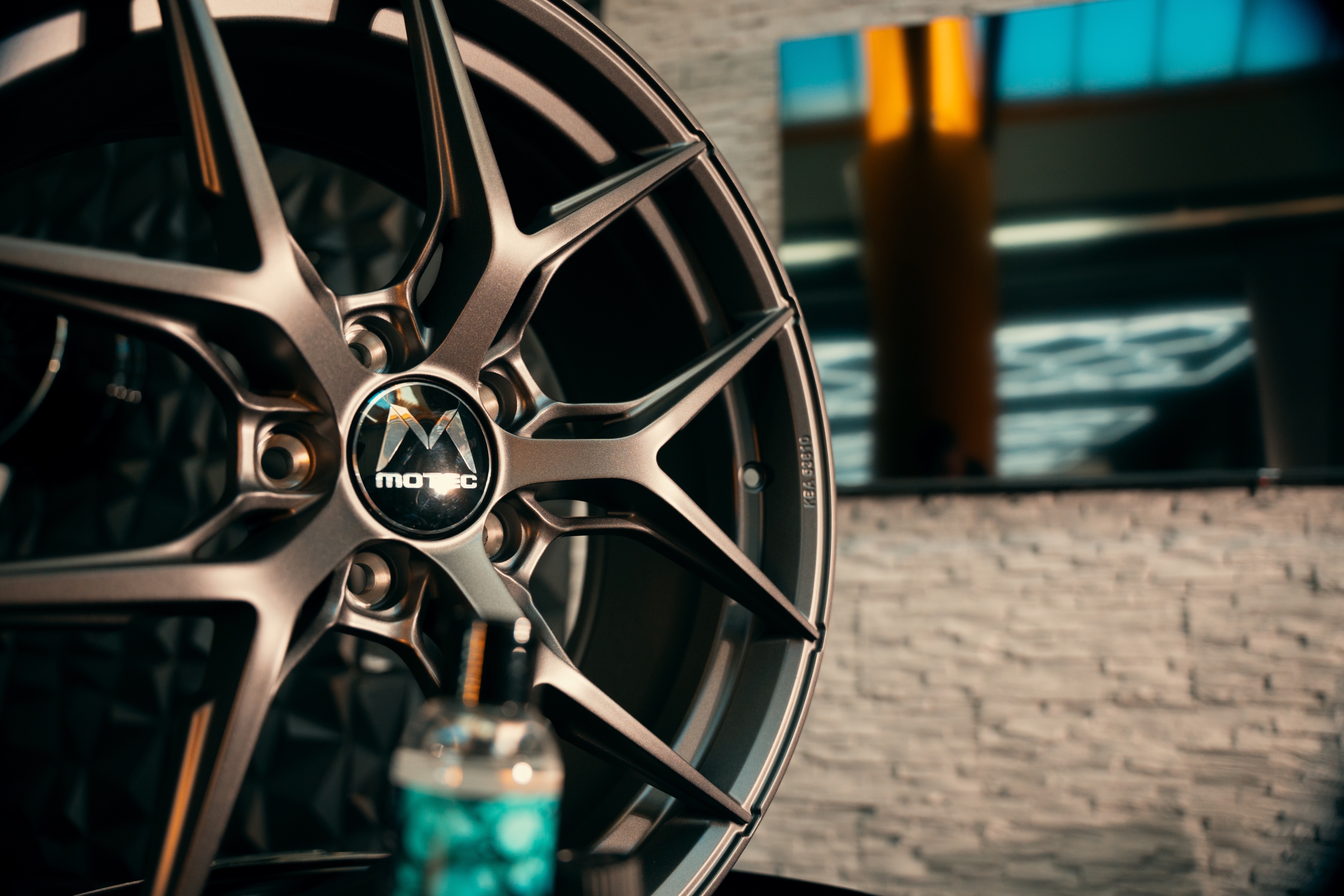 C² Wheel Ceramic Stage 3 — Ceramic coating application on alloy wheel spoke with precision applicator